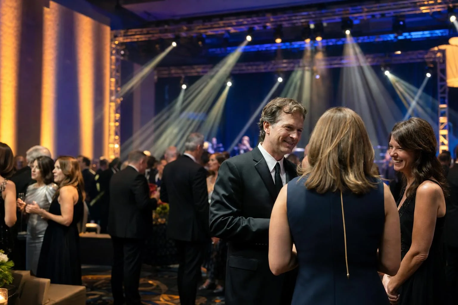 Gala ballroom with amber and blue LED uplighting and moving head light beams