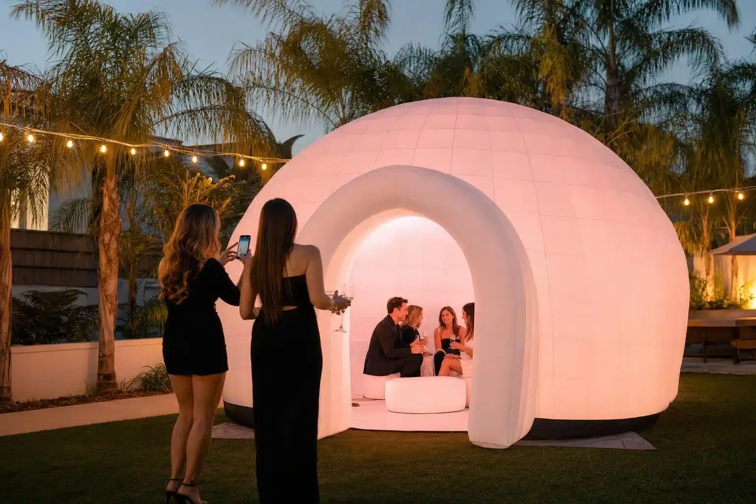 10 x 10 ft inflatable LED igloo glowing pink at a backyard party in Los Angeles